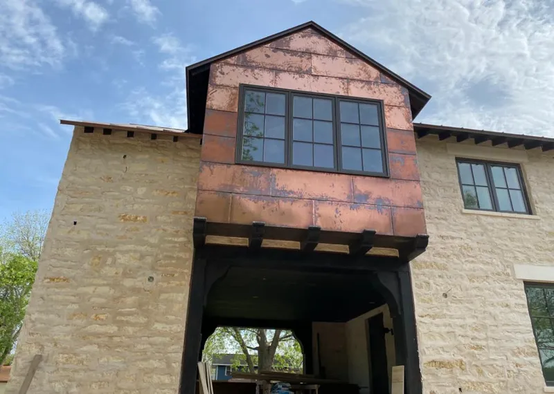 Copper metal panel facade on a stone building for Metal Roof Coating in On Top of the World