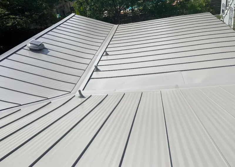 Solar attic fan installed on a metal roof for Roof Ventilation in On Top of the World